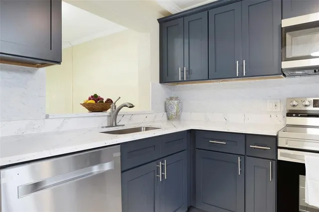 a kitchen with a sink cabinets and a window