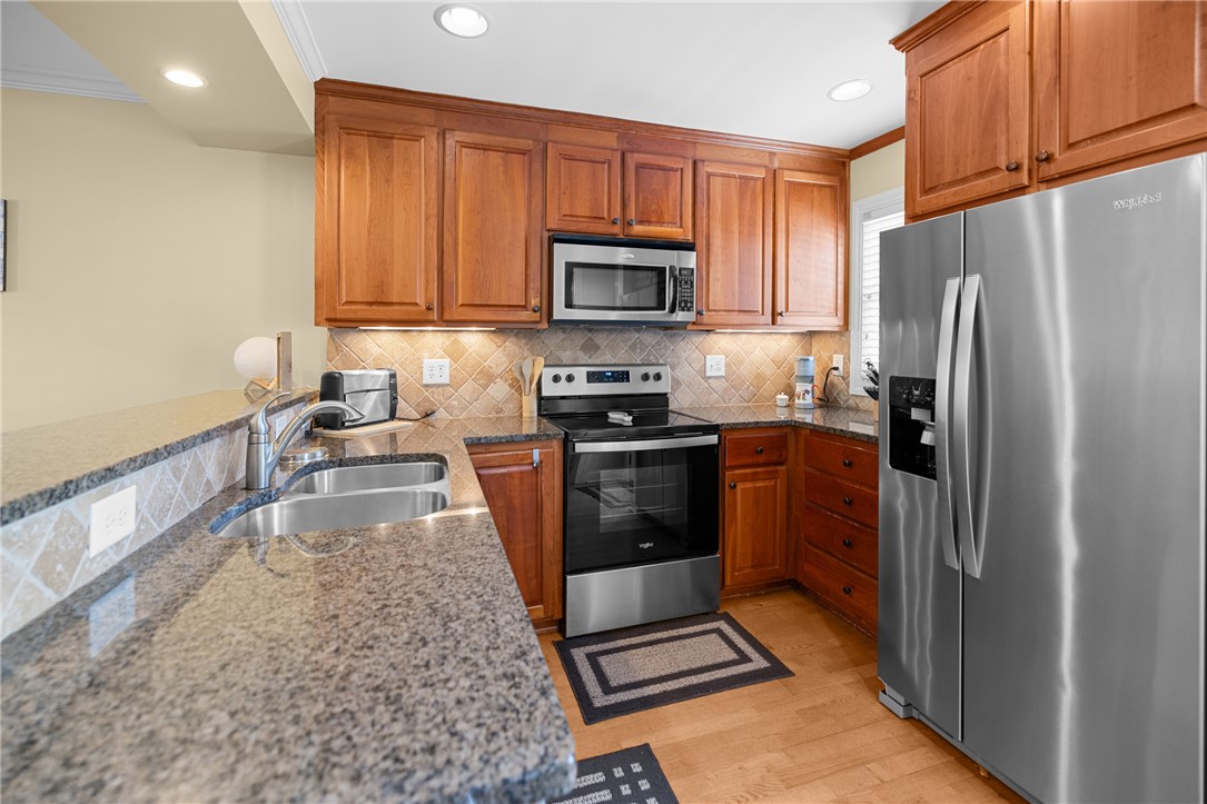 209 Calhoun Street, Unit 201 Clemson, SC 29631 - Photo 12 of 35 This warm and inviting kitchen boasts ample counter space, rich cabinetry, and modern appliances.
