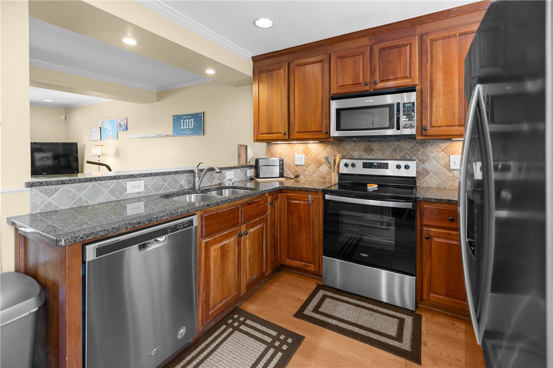209 Calhoun Street, Unit 201 Clemson, SC 29631 - Photo 13 of 35 This kitchen showcases stainless steel appliances and ample cabinetry, offering both style and functionality.