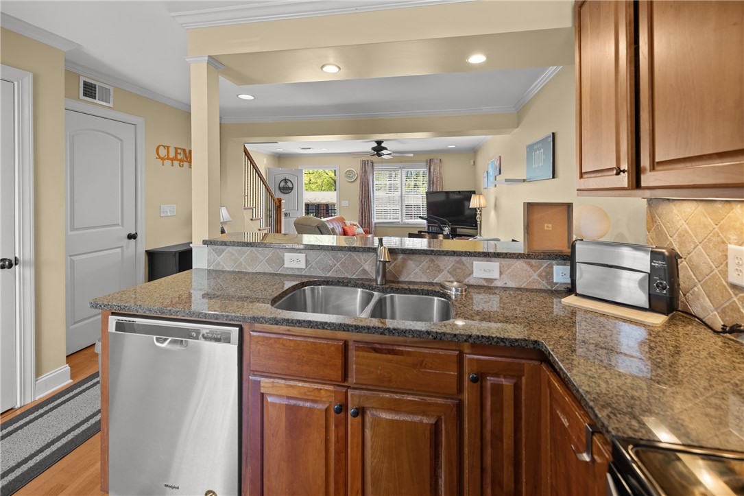 209 Calhoun Street, Unit 201 Clemson, SC 29631 - Photo 14 of 35 This functional kitchen features ample counter space, a double basin sink, and open views to the living area.