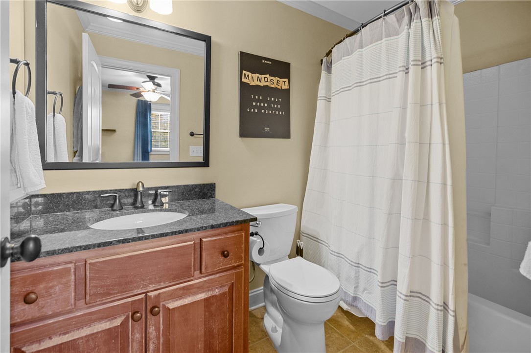 209 Calhoun Street, Unit 201 Clemson, SC 29631 - Photo 20 of 35 This bathroom features a single vanity with a dark granite countertop and a combination tub and shower.
