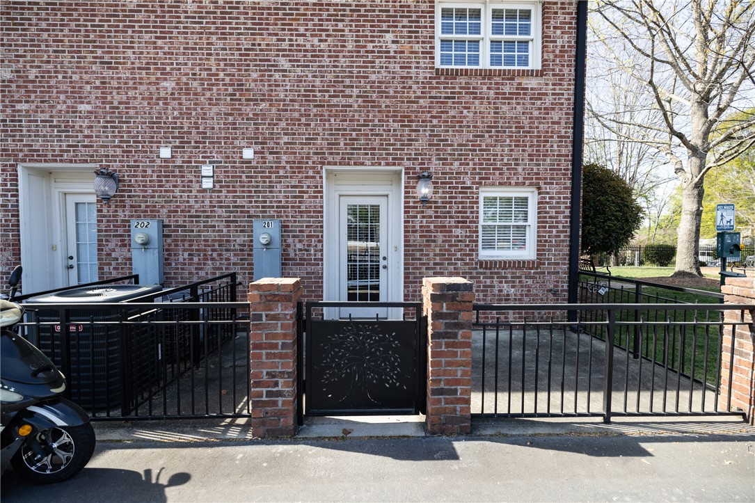 209 Calhoun Street, Unit 201 Clemson, SC 29631 - Photo 25 of 35 This residence features a charming brick exterior with inviting patio space, perfect for outdoor enjoyment.