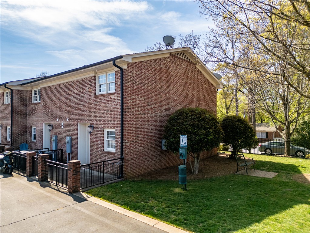 209 Calhoun Street, Unit 201 Clemson, SC 29631 - Photo 28 of 35 This brick multi-unit building features a well-maintained lawn and convenient outdoor spaces.