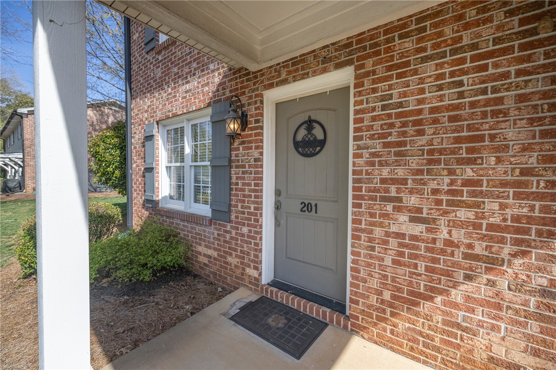 209 Calhoun Street, Unit 201 Clemson, SC 29631 - Photo 3 of 35 The inviting entrance features classic brick and a welcoming doorway.
