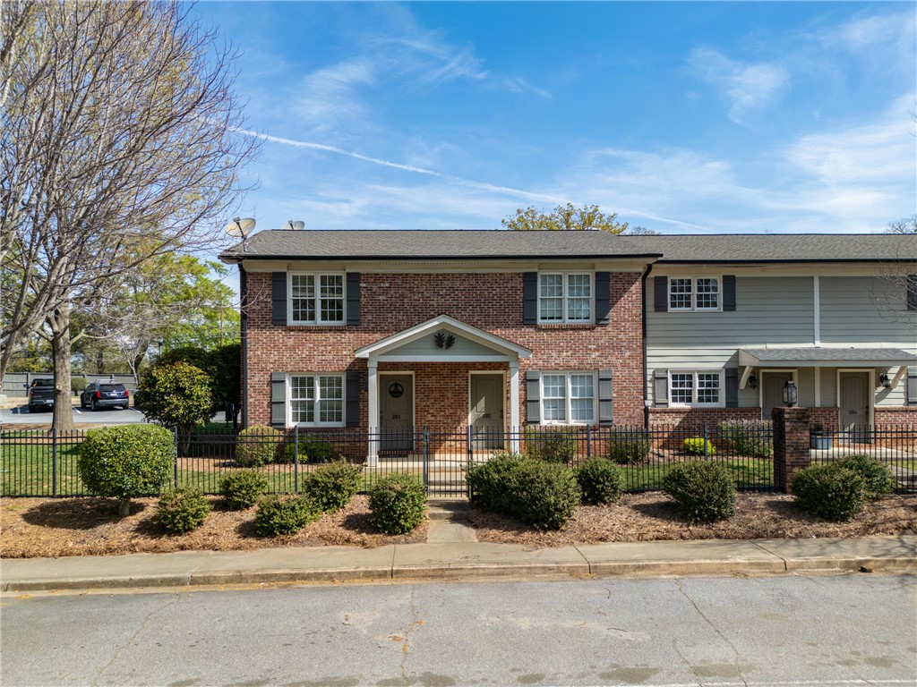 209 Calhoun Street, Unit 201 Clemson, SC 29631 - Photo 5 of 35 This charming townhome offers classic brick and siding with a welcoming front entrance.