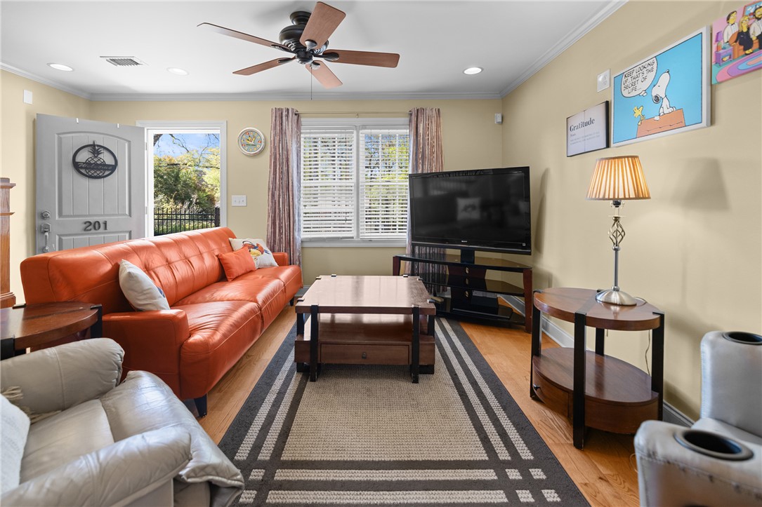 209 Calhoun Street, Unit 201 Clemson, SC 29631 - Photo 7 of 35 This inviting living area boasts rich hardwood floors and abundant natural light.