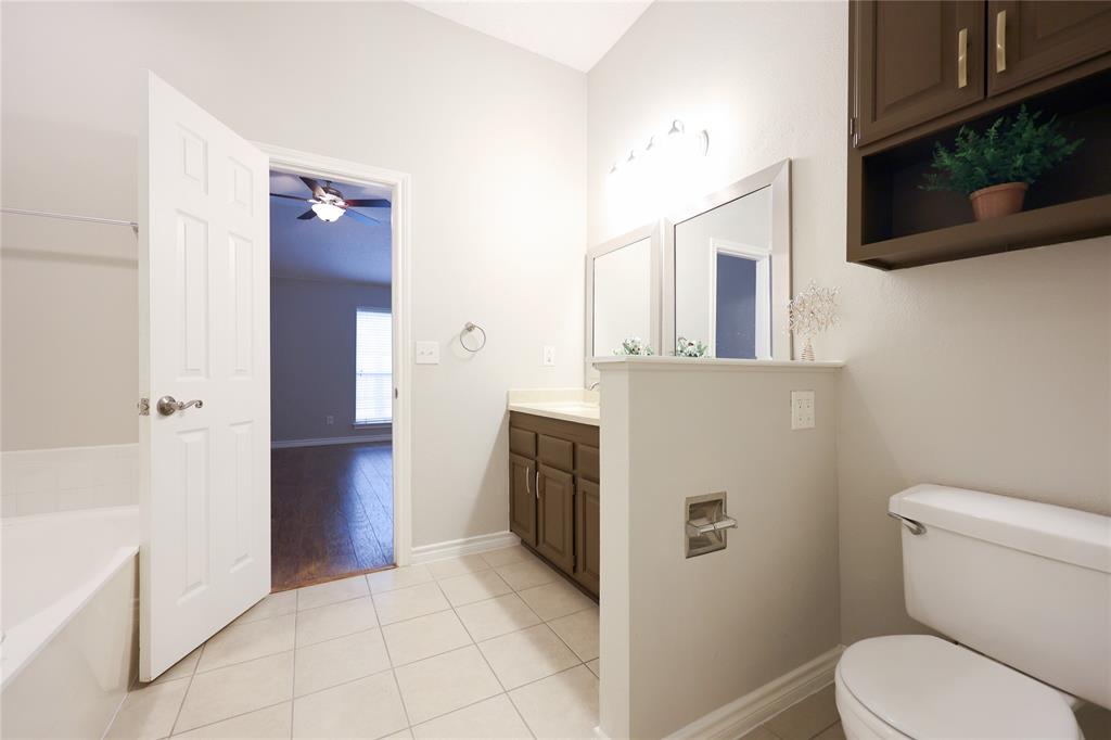 8112 Dock Street Frisco, TX 75035 - Photo 22 of 34 a bathroom with a toilet sink and mirror