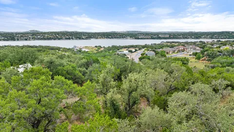 a view of a green field with an ocean view