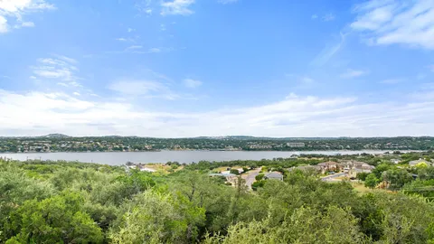 a view of a lake with houses in the back