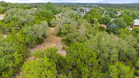 a view of a forest with a street