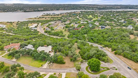 an aerial view of residential houses with outdoor space and swimming pool