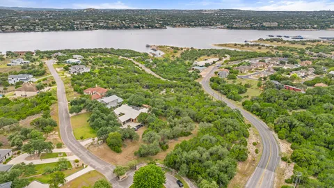 an aerial view of a houses with a lake view
