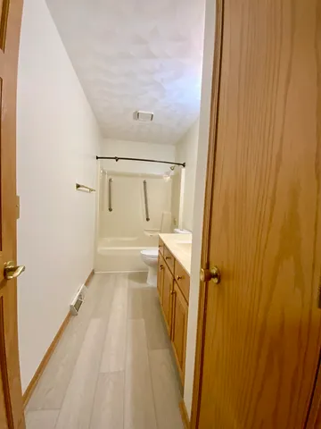 a room with a bed and a chandelier