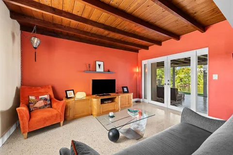 a work room with furniture and a flat screen tv