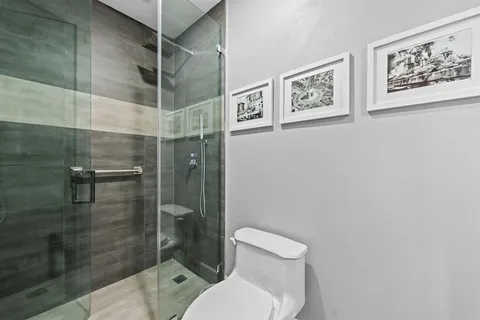 a bathroom with a toilet and shower