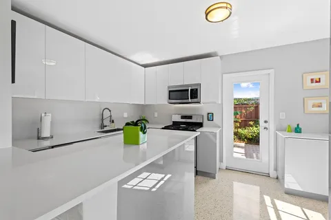 a kitchen with a sink a counter top space and appliances