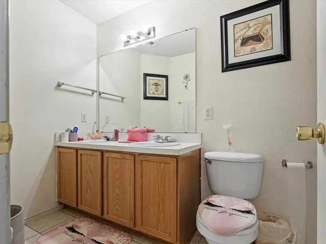 a bathroom with a toilet a sink and a mirror