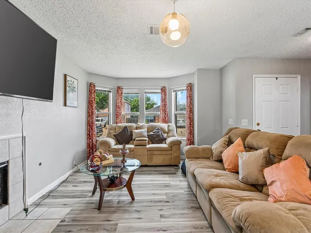 a living room with furniture wooden floor and a flat screen tv