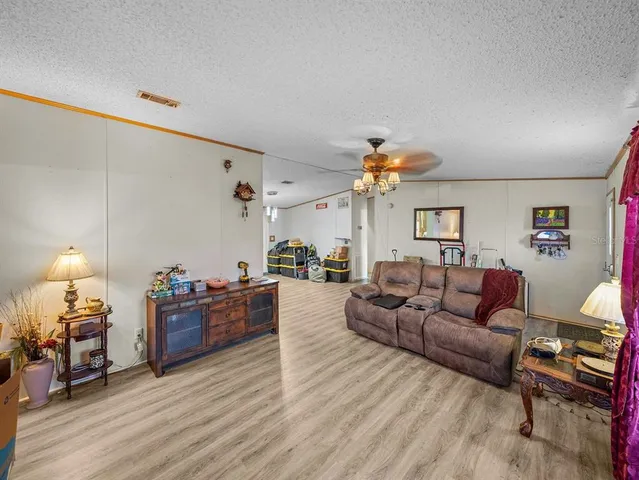 a kitchen with granite countertop a sink dishwasher stove and oven with wooden floor
