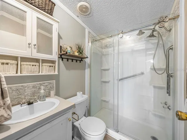 a bathroom with a double vanity sink mirror and shower
