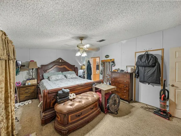 a living room with patio furniture and a chandelier