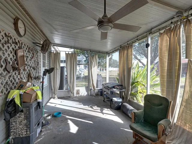 a backyard of a house with barbeque oven table and chairs