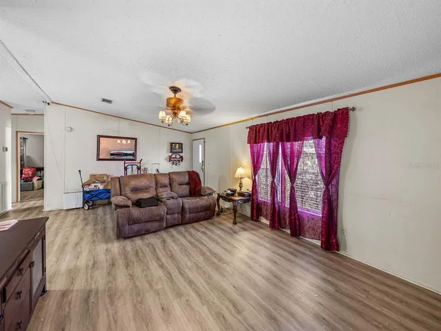 a living room with furniture a flat screen tv and a dresser