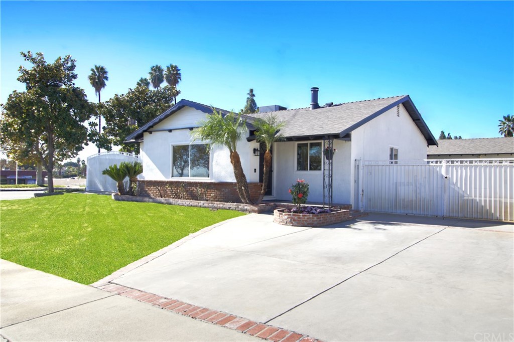 7286 Topaz Street Rancho Cucamonga, CA 91701 - Photo 1 of 1 a front view of a house with a garden and tree
