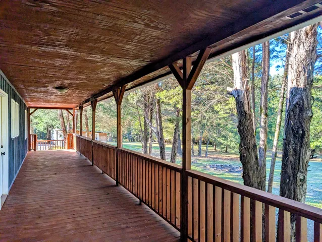 a view of a porch with wooden floor and outdoor space