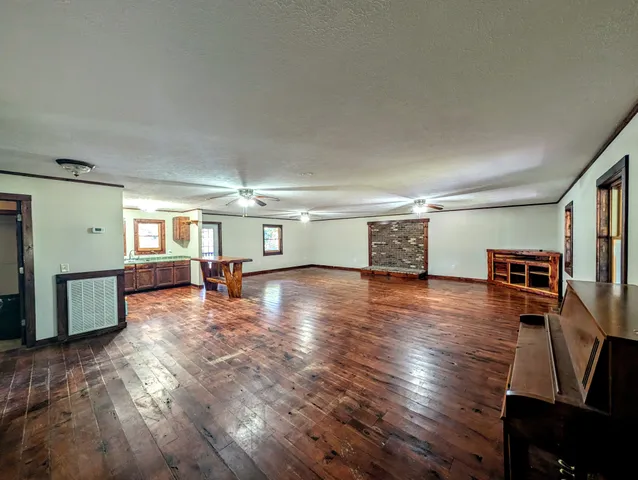 a view of a livingroom with hardwood and furniture