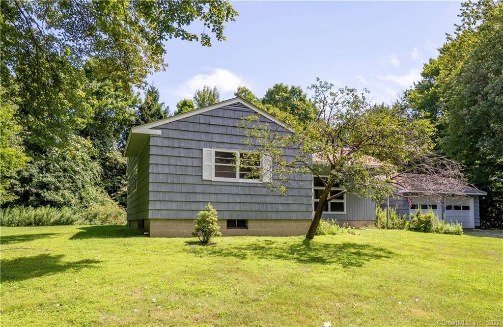 144 Silver Spring Lane Ridgefield, CT 06877 - Photo 1 of 1 a front view of a house with a yard
