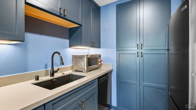 a kitchen with a sink and cabinets