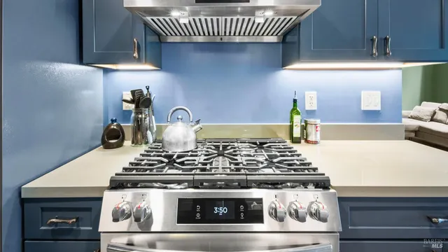 a stove sitting inside of a kitchen with granite countertop