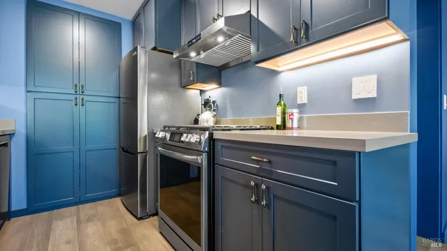 a kitchen with stainless steel appliances a refrigerator and a sink