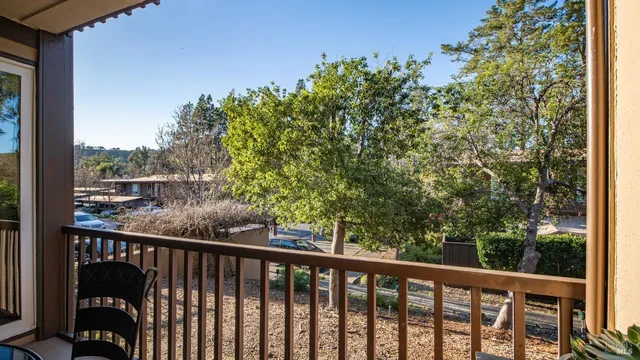 a view of a balcony with wooden fence and floor