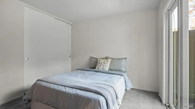 a bed sitting in a bedroom next to a window