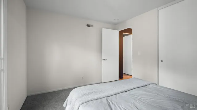 a bedroom with a bed and a mirror