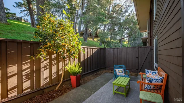 a backyard of a house with fountain table and chairs