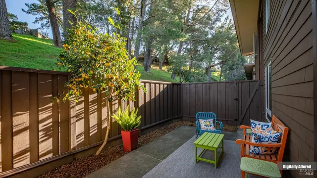 a backyard of a house with fountain table and chairs