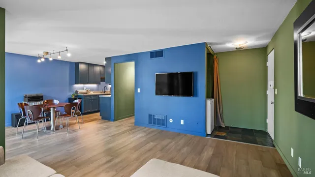 a view of a livingroom with furniture and an empty room