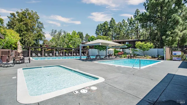 a view of a swimming pool with sitting area