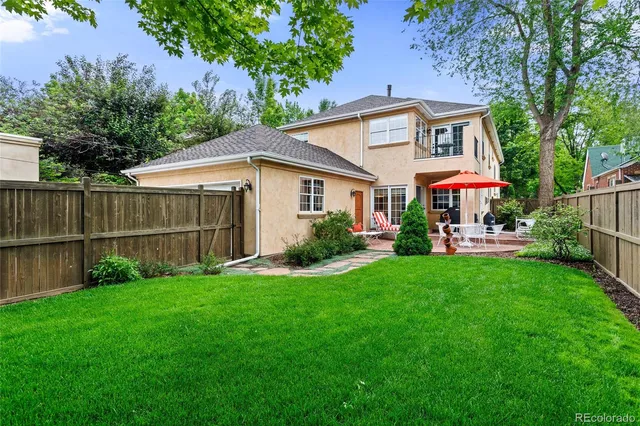 a view of a house with a yard and sitting area