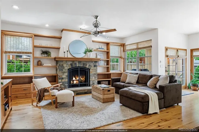 a living room with furniture a large window and a fireplace