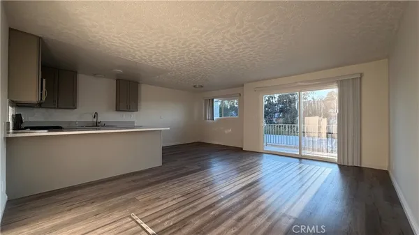 a view of a kitchen with wooden floor and a sink