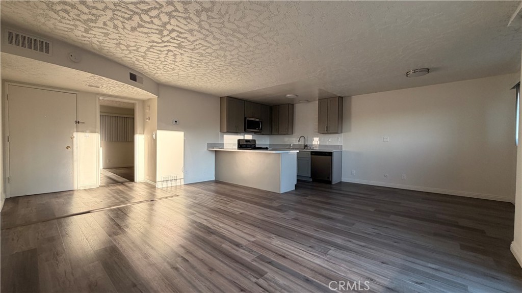 1831 Garvey Avenue, Unit 9 Alhambra, CA 91803 - Photo 2 of 12 a view of a kitchen with a sink and a stove top oven