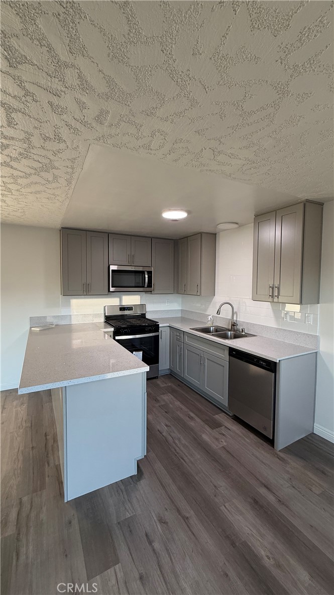 1831 Garvey Avenue, Unit 9 Alhambra, CA 91803 - Photo 4 of 12 a large kitchen with stainless steel appliances and a sink