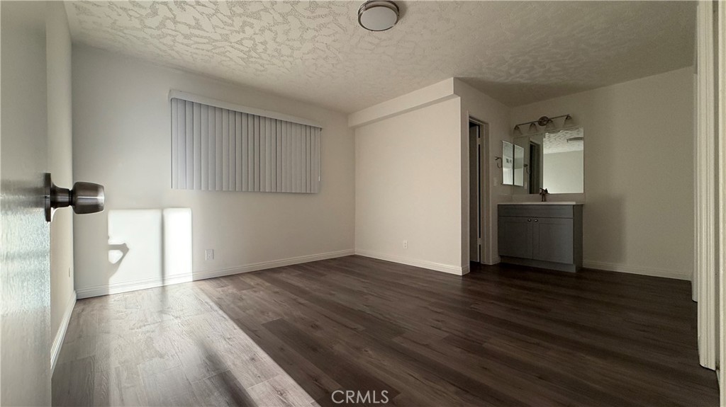 1831 Garvey Avenue, Unit 9 Alhambra, CA 91803 - Photo 8 of 12 wooden floor in an empty room with a window