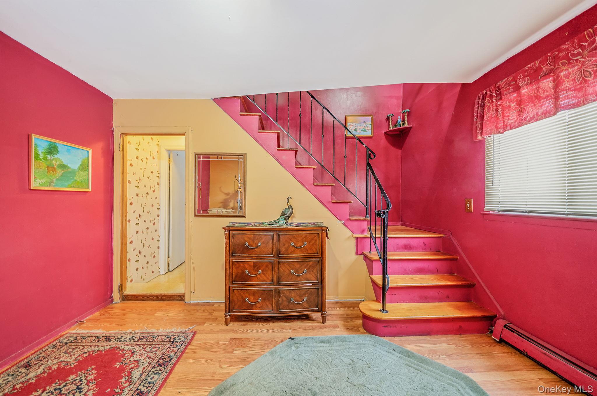 244 Lakeside Trail Ridge, NY 11961 - Photo 13 of 36 Stairs featuring a baseboard heating unit and wood finished floors