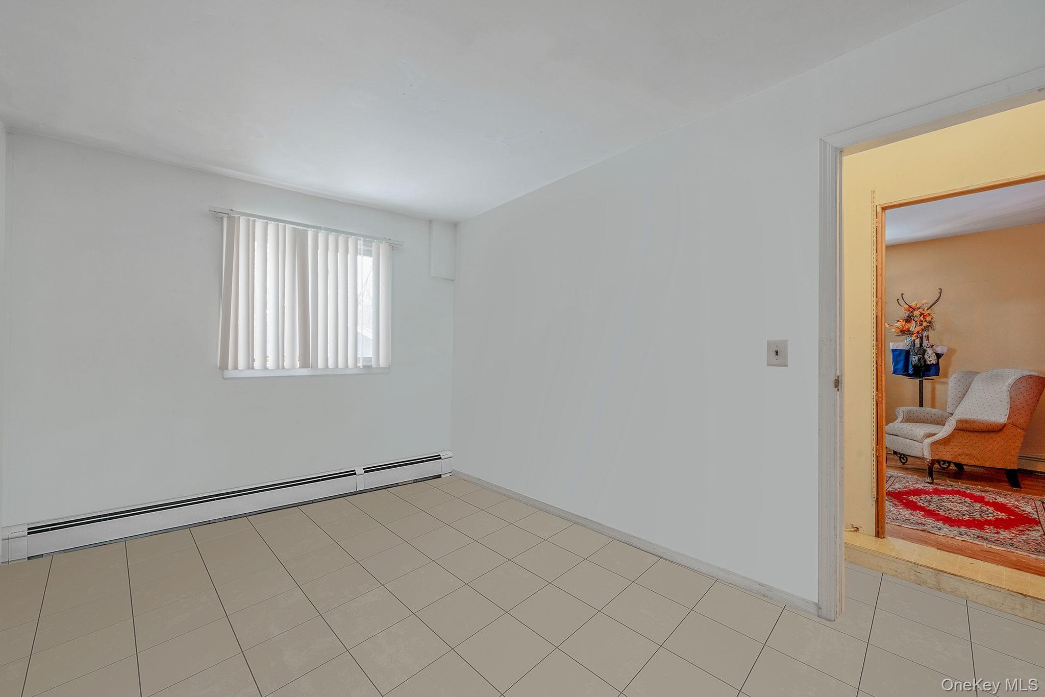 244 Lakeside Trail Ridge, NY 11961 - Photo 19 of 36 Spare room featuring a baseboard radiator