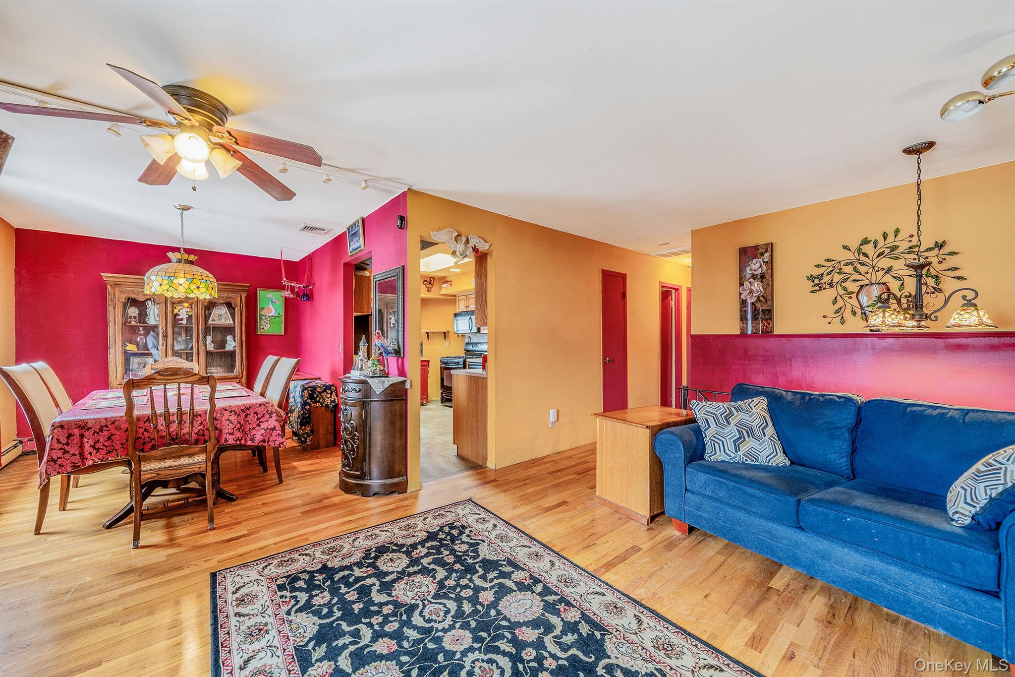 244 Lakeside Trail Ridge, NY 11961 - Photo 24 of 36 Living room with a chandelier, wood finished floors, and ceiling fan
